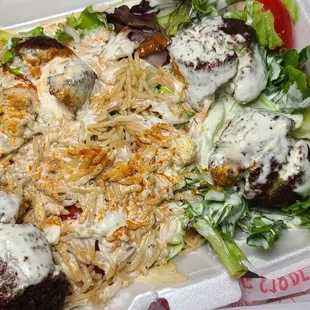 Falafel over salad add rice and hot sauce.