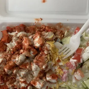 Salad, Chicken over rice with white sauce and hot sauce.