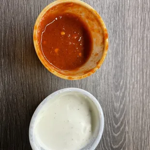 a bowl of sauce and a bowl of dip