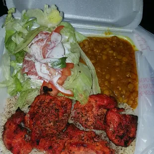 Chicken Kabob platter with rice, salad, lentils and naan bread. As you can see spices are packed on it lol