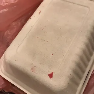 Raw meat on box of cooked deli meats. Extremely unhygienic.