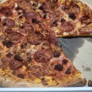 a half eaten pizza in a box