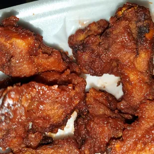 chicken wings and rice in a styrofoam container