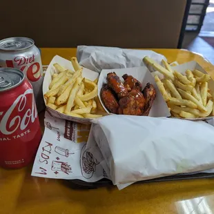 Fries, turkey bacon sandwich and buffalo wings