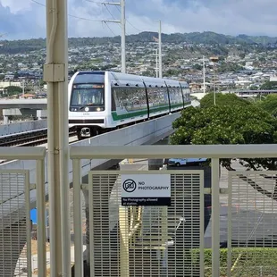 Train approaching the station that will turn right back around 3 minutes later. No photos allowed, but not sure why.