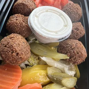 a tray of vegetables and meatballs
