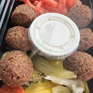 a variety of vegetables and meatballs