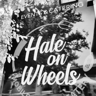 a black and white photo of a sign that says hale on wheels