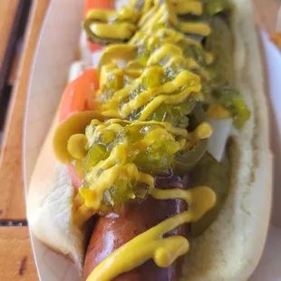 a hot dog with mustard and relish