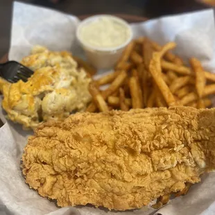 a basket of fried fish and fries