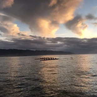 Sunset cruise with the local canoe club practicing in the background.