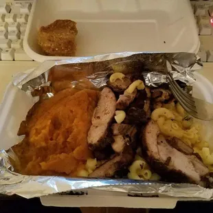 Jerk chicken with mac and cheese and sweet potato mash