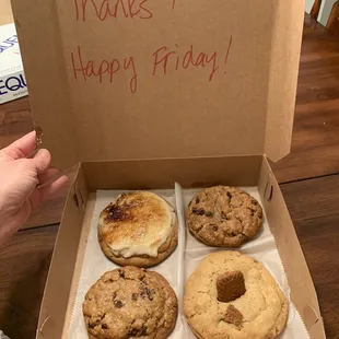 a person holding a box of cookies