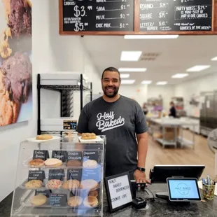 a man standing behind a counter