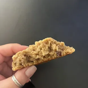 a hand holding a half eaten cookie