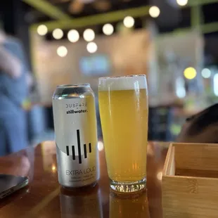 a glass of beer and a can of beer