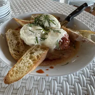 Meatballs  a trio of veal, beef, and pork meatballs, Sunday gravy, three cheese blend, parsley,  toasted garlic bread