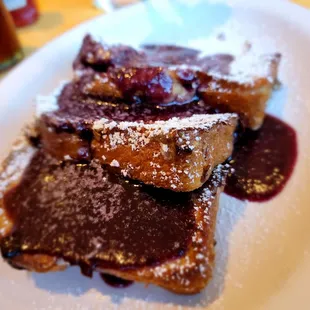 a plate of french toast with raspberry sauce