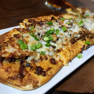 November 14, 2022; Sausage flatbread ($18).