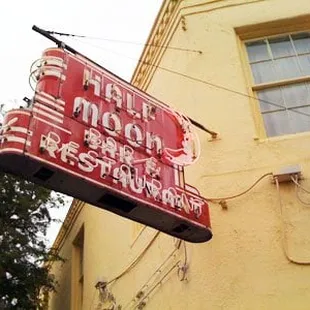 neon sign for half moon restaurant