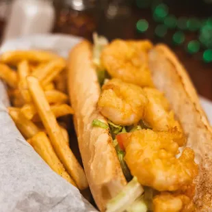 Fried Shrimp Po-Boy, dressed with lettuce, tomato, onion &amp; pickles. French Fries on the side