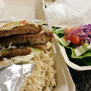 A gyro dinner with salad &amp; rice