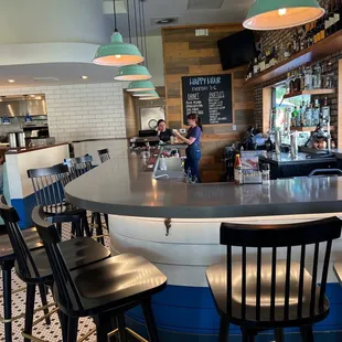 a restaurant with a counter and chairs