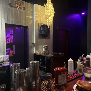 a kitchen with a bar and a purple light