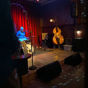 a musician and a bass player in a dimly lit room