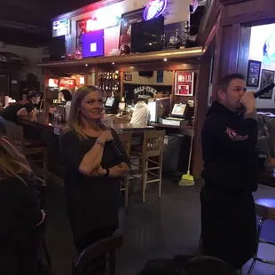 a group of people sitting at a bar
