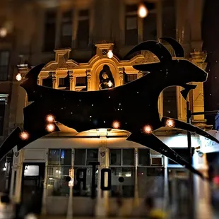 a building with a clock and a goat on it