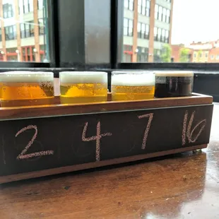 a row of beer glasses on a table