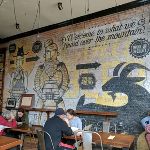 people sitting at tables in a restaurant