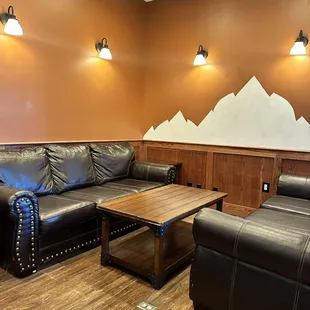 a living room with leather furniture