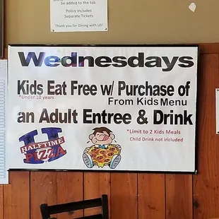 a restaurant with a menu on the wall