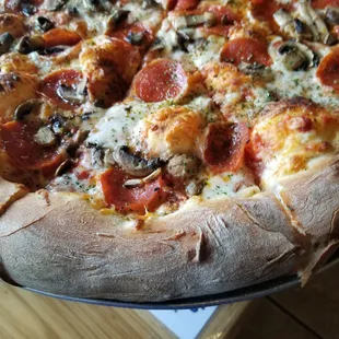 a pizza with pepperoni, mushrooms, and cheese