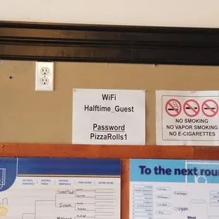 a bulletin board with a bunch of signs on it