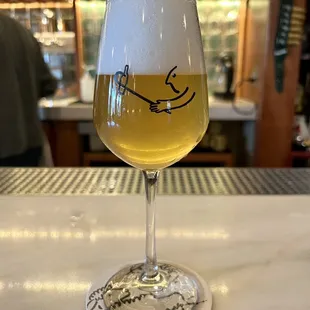 a glass of beer on a bar