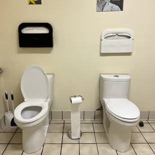 two toilets in a restroom
