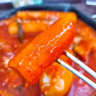 a close up of a hot dog on a stick