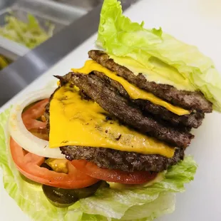 a hamburger with lettuce and cheese