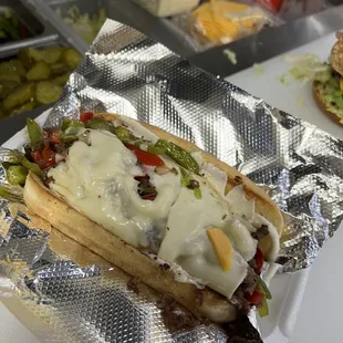 a hot dog covered in cheese