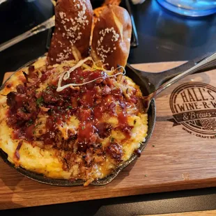 ows a skillet with a pizza and a bagel