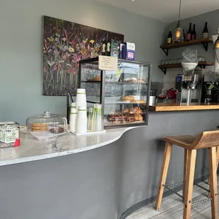 a counter with two wooden stools