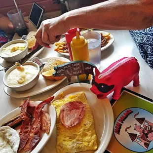 a breakfast of eggs, bacon, toast, and coffee