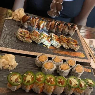 a woman sitting at a table with sushi