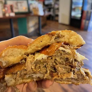 Three little pigs special cross section (tonkatsu, Kalua and bacon on brioche with fried egg, Swiss and mustard Mayo) with fries