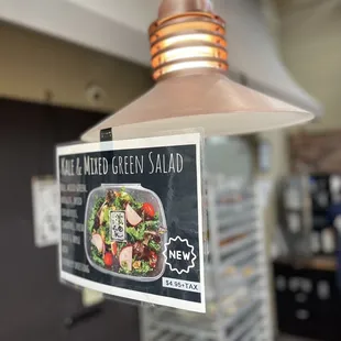 a menu attached to a light fixture