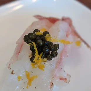 Fresh shrimp with caviar and orange zest
