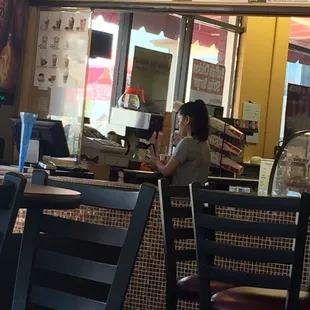 Cashier too bizzy on her cell to tend to customers